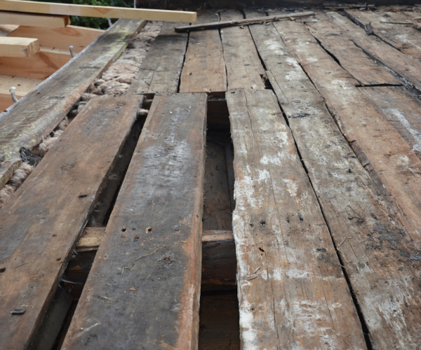 Timber damage caused by wet rot showing soft, dark wood